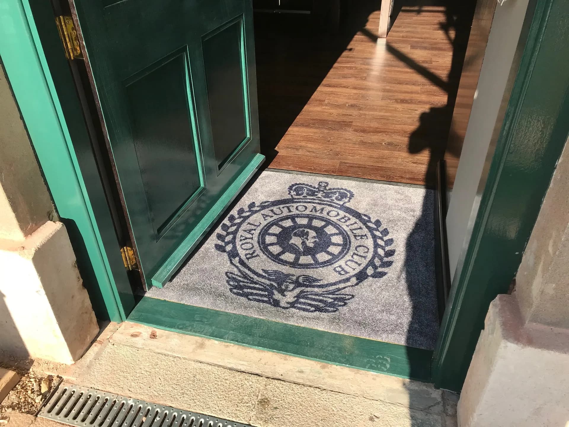 The Royal Automobile Club crest set into the entrance floor at Woodcote Park