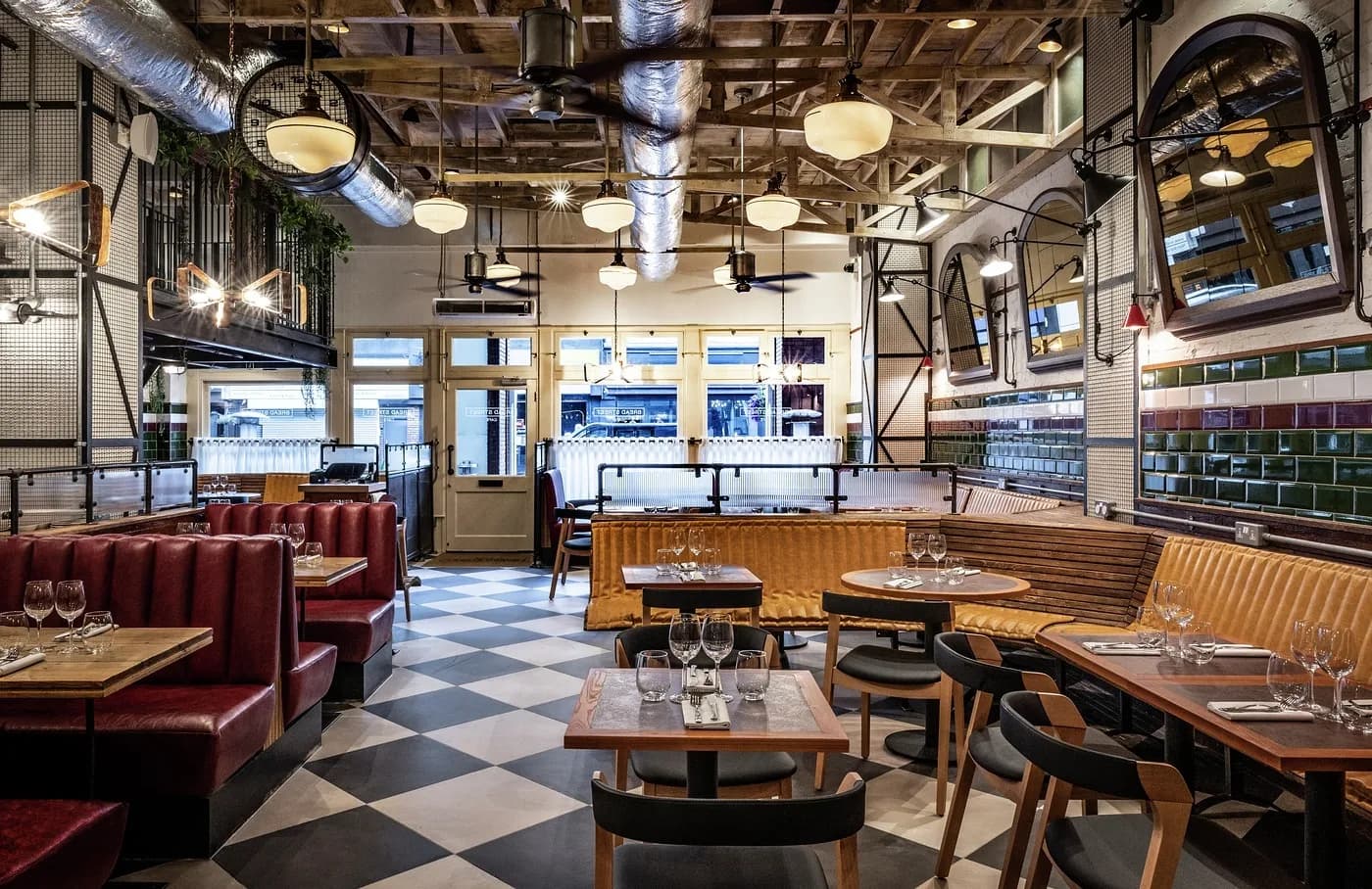 Chequerboard floor, leather banquettes and pendant lighting at Gordon Ramsay Street Pizza, Ealing, fitted out by JPS Services