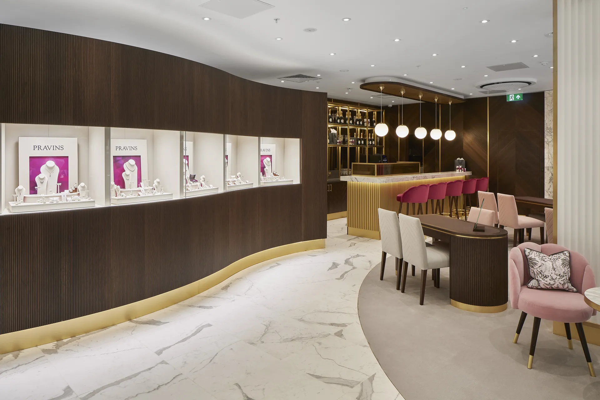 Curved fluted joinery, marble floor and velvet seating in the Pravins boutique at Milton Keynes, fitted out by JPS Services